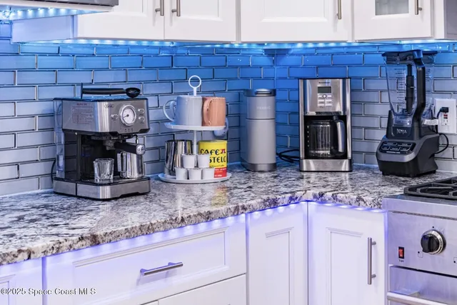 a kitchen with granite countertop wooden cabinets and a counter top space