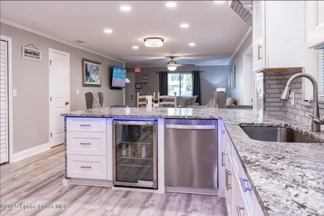 a kitchen with a stove a sink and a refrigerator