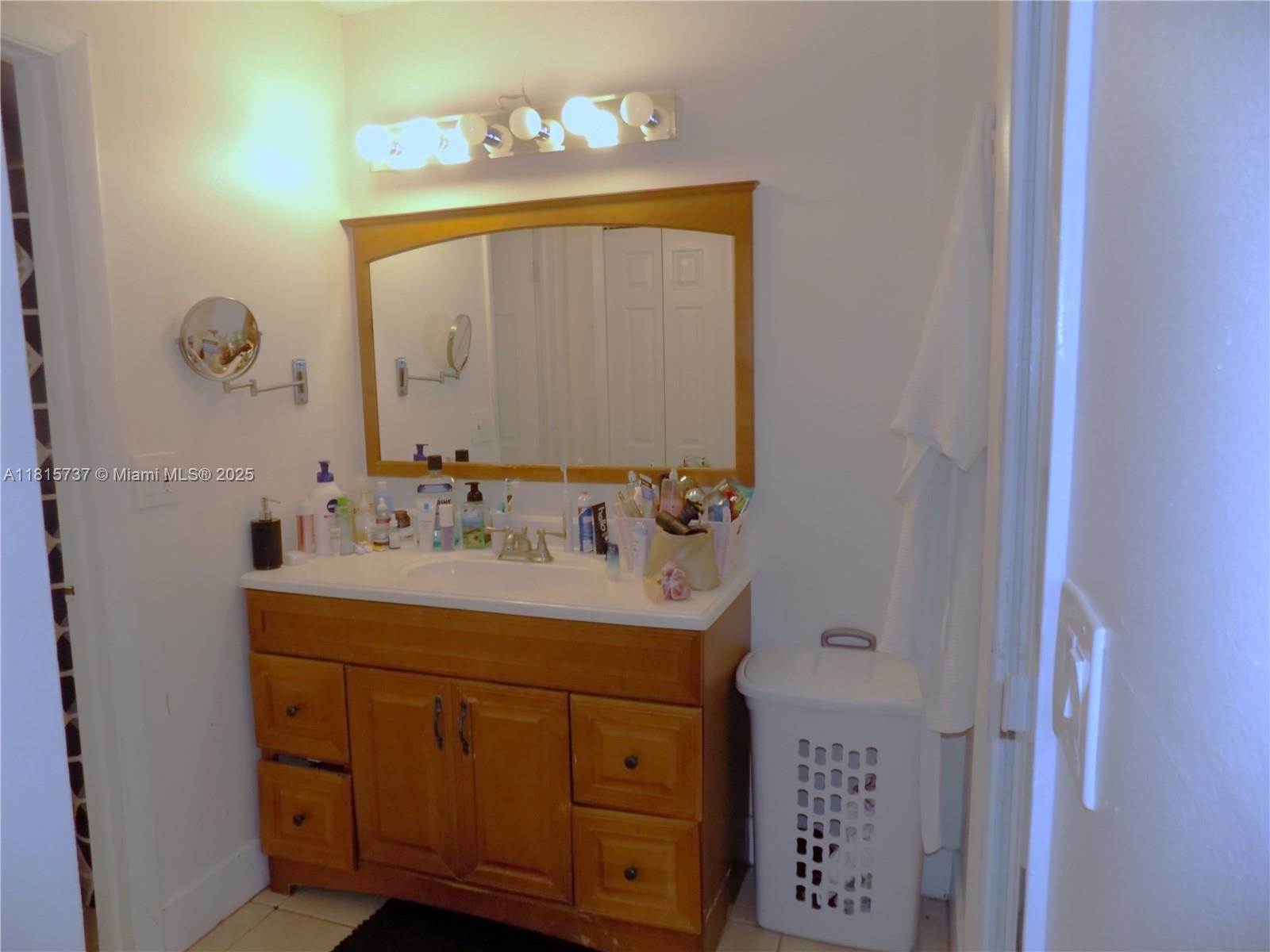 Bonaventure Weston, FL 33326 - Photo 11 of 16 a bathroom with a sink vanity and mirror