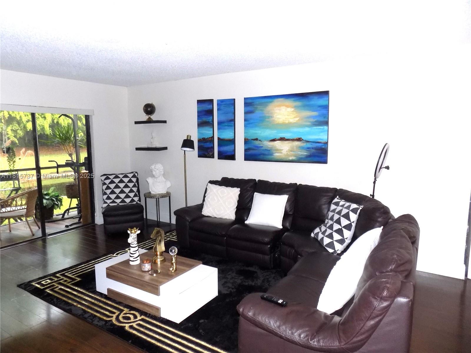 Bonaventure Weston, FL 33326 - Photo 5 of 16 a living room with furniture and a flat screen tv