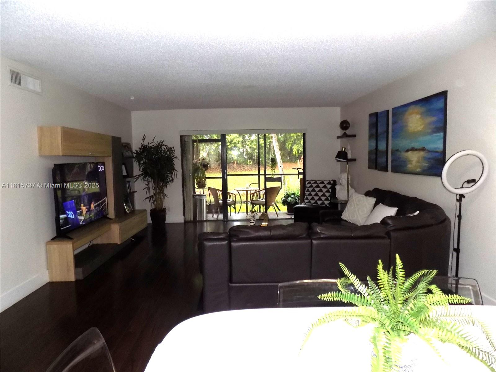 Bonaventure Weston, FL 33326 - Photo 6 of 16 a living room with furniture and a flat screen tv