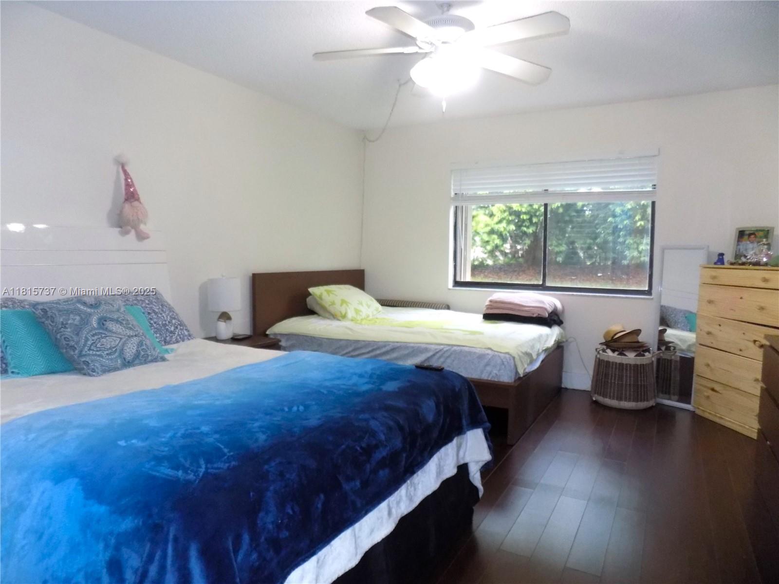 Bonaventure Weston, FL 33326 - Photo 10 of 16 a bedroom with a bed and wooden floor