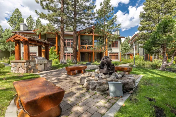 a view of a house with backyard water fountain and sitting area