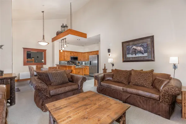 a living room with furniture a bed and a chandelier
