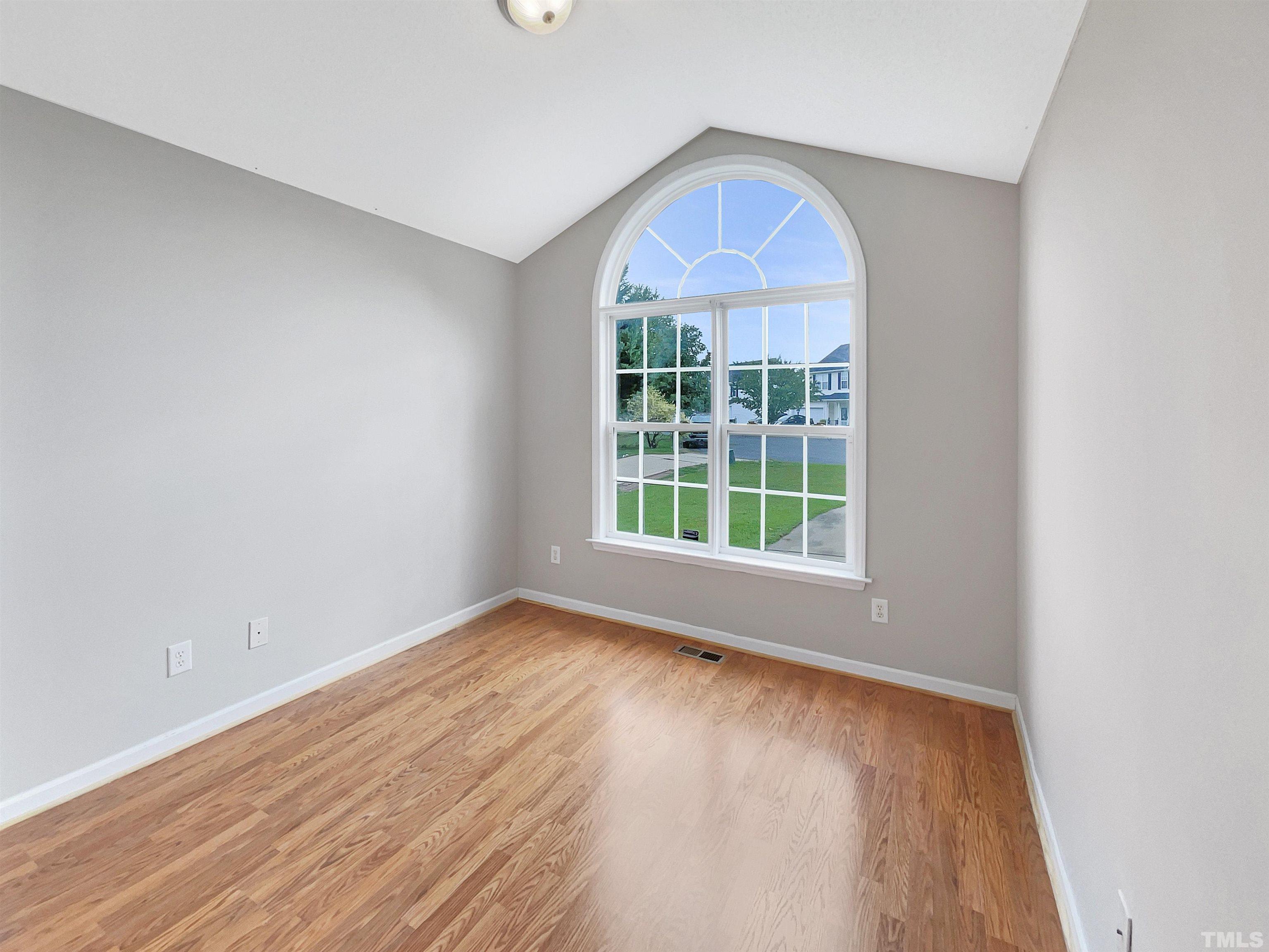 3626 Enduring Freedom Drive Raleigh, NC 27610 - Photo 11 of 17 an empty room with wooden floor and a window
