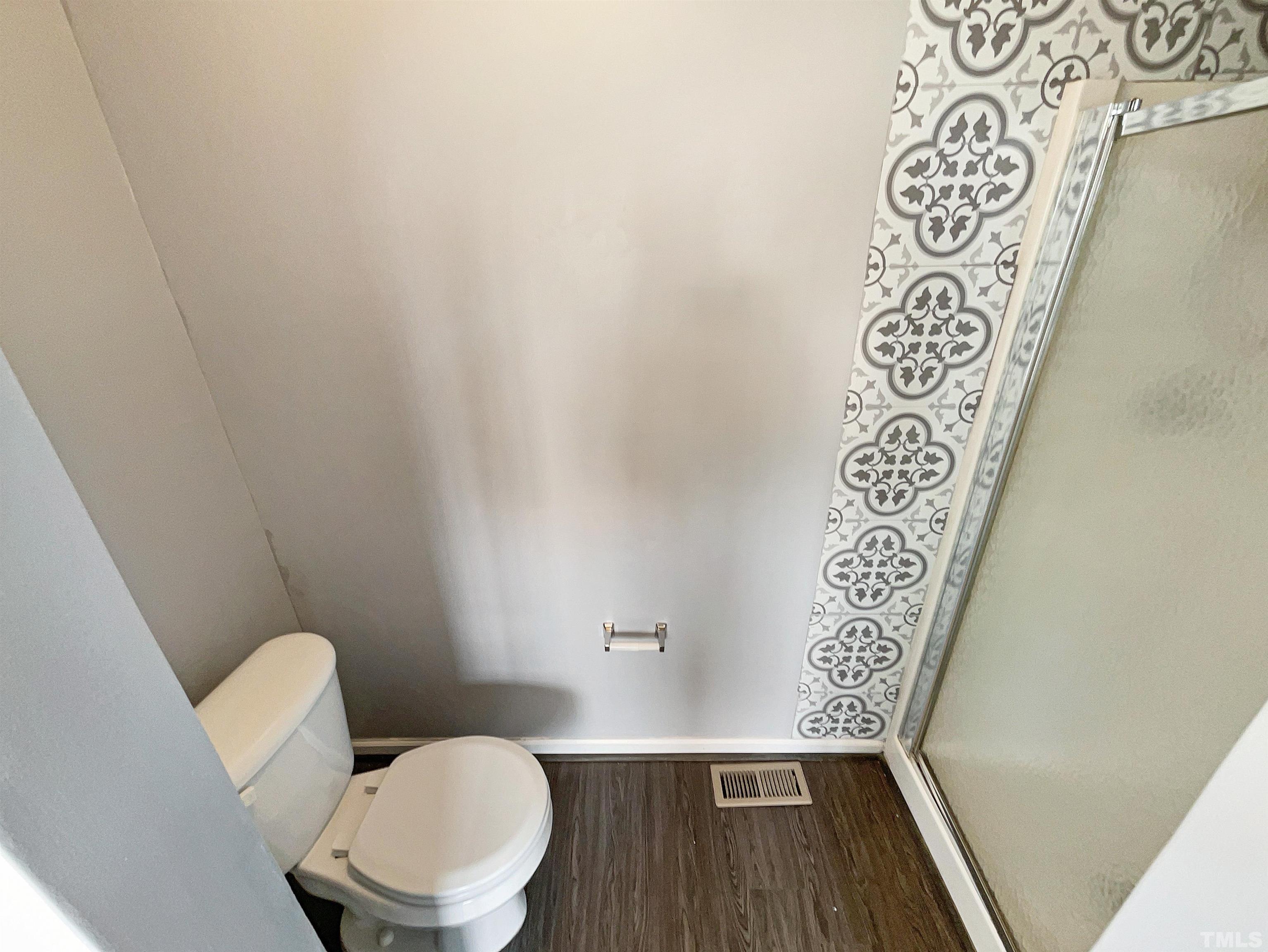 3626 Enduring Freedom Drive Raleigh, NC 27610 - Photo 16 of 17 a bathroom with a toilet and a shower curtain