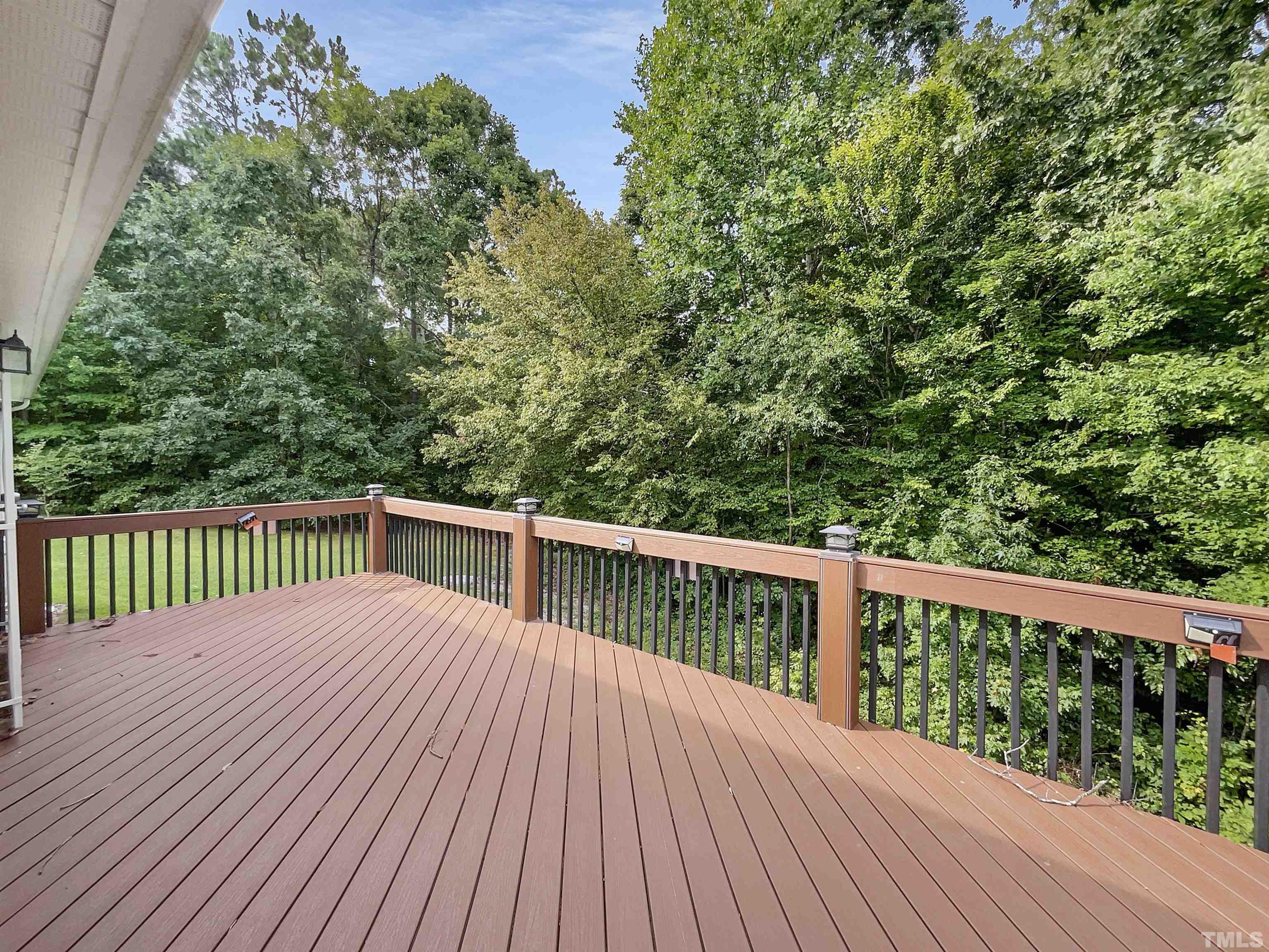 3626 Enduring Freedom Drive Raleigh, NC 27610 - Photo 17 of 17 a balcony with wooden floor and trees in the back
