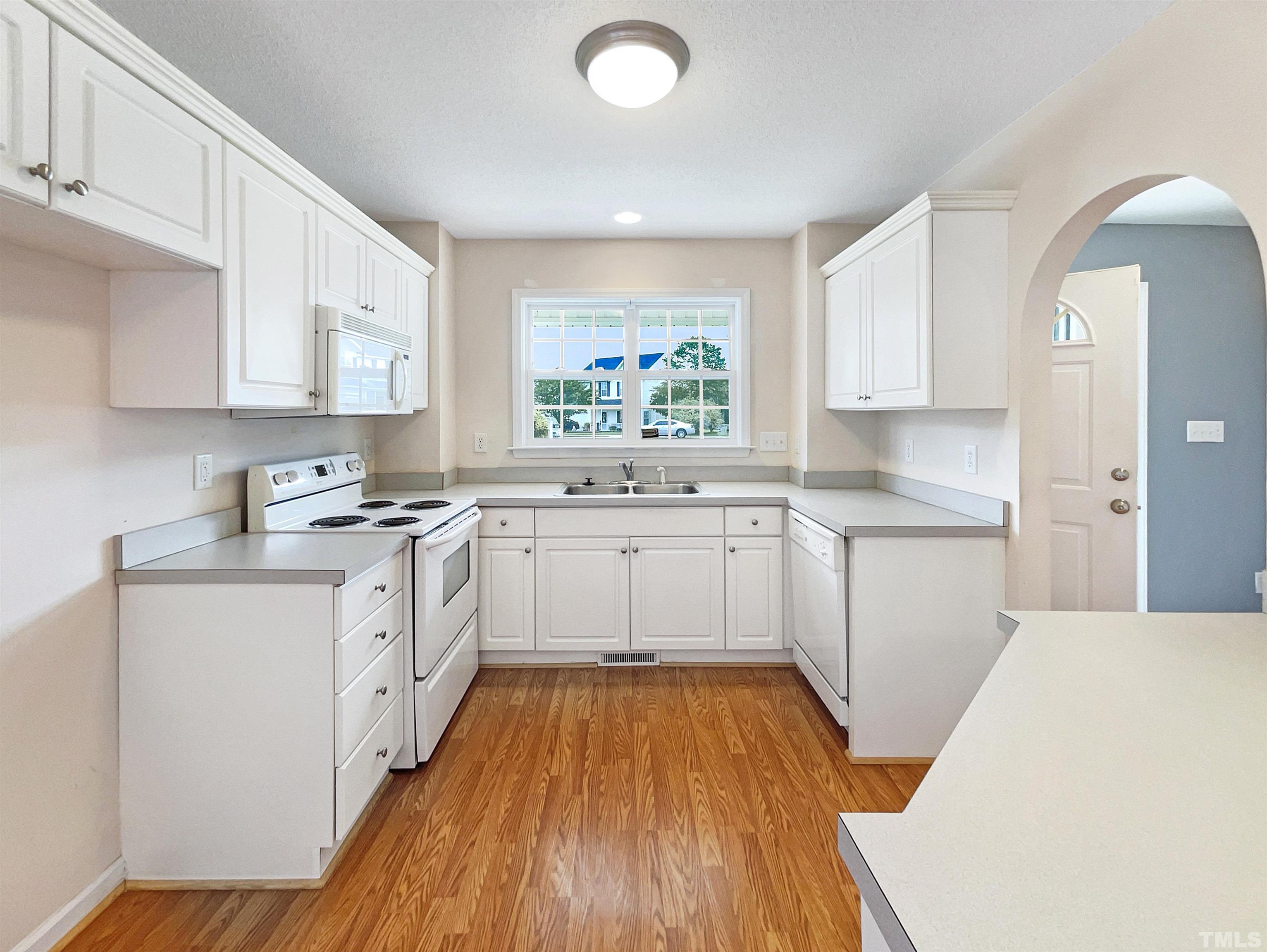 3626 Enduring Freedom Drive Raleigh, NC 27610 - Photo 2 of 17 a kitchen with granite countertop a sink cabinets stainless steel appliances and a window