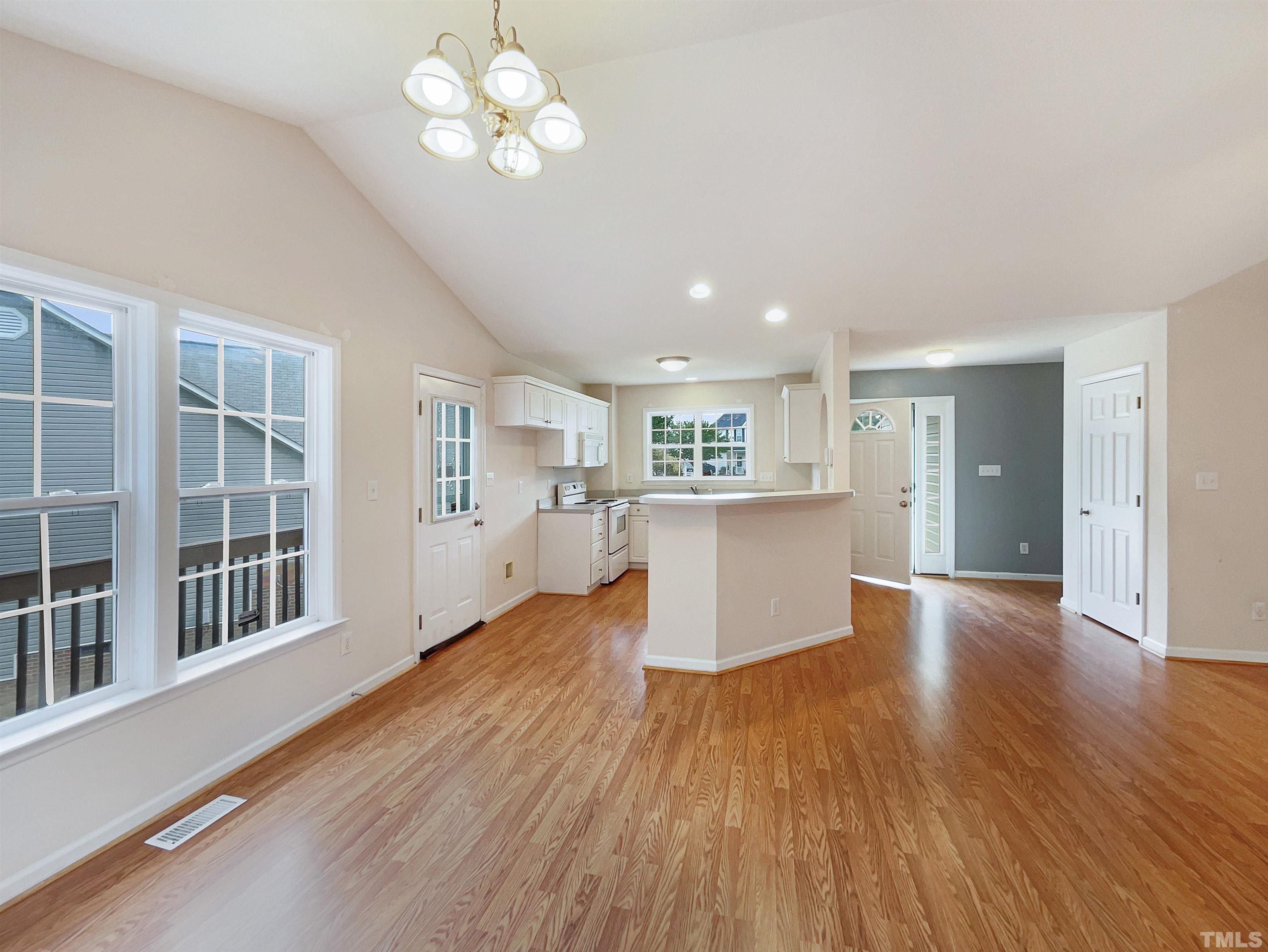3626 Enduring Freedom Drive Raleigh, NC 27610 - Photo 8 of 17 a view of a big room with wooden floor and windows
