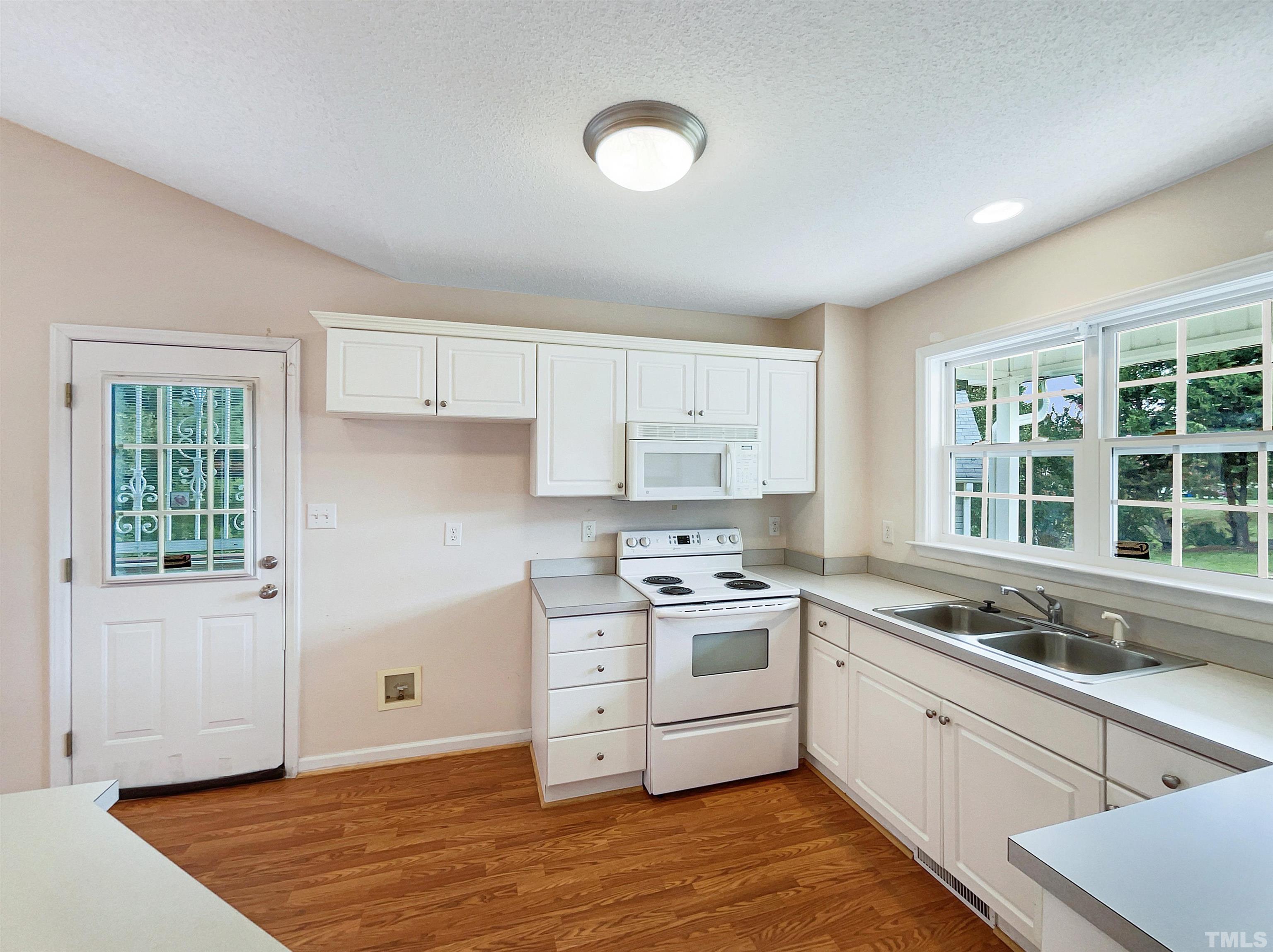 3626 Enduring Freedom Drive Raleigh, NC 27610 - Photo 9 of 17 a kitchen with stainless steel appliances granite countertop a stove a sink and a refrigerator