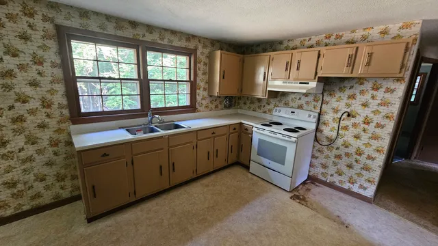 a kitchen with a sink stove and cabinets