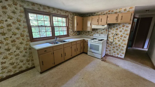 a kitchen with stainless steel appliances a stove a refrigerator sink and cabinets