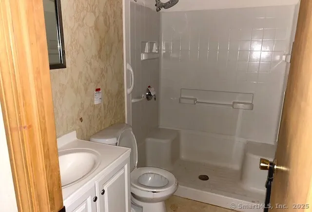 a bathroom with a sink toilet and shower