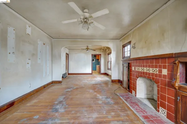 a view of livingroom with hallway and a fireplace
