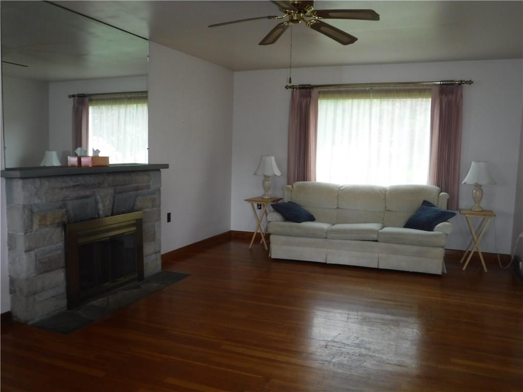 1425 Harvey Run Road Freedom, PA 15042 - Photo 7 of 25 Living room hardwood floors and wood burning fireplace