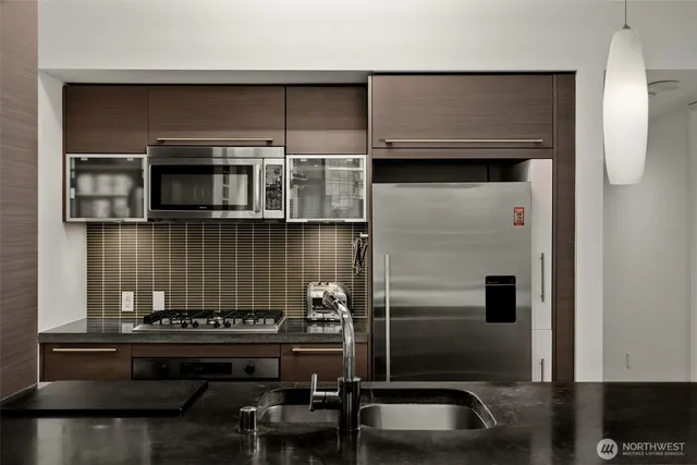 a kitchen with a sink and a stove top oven