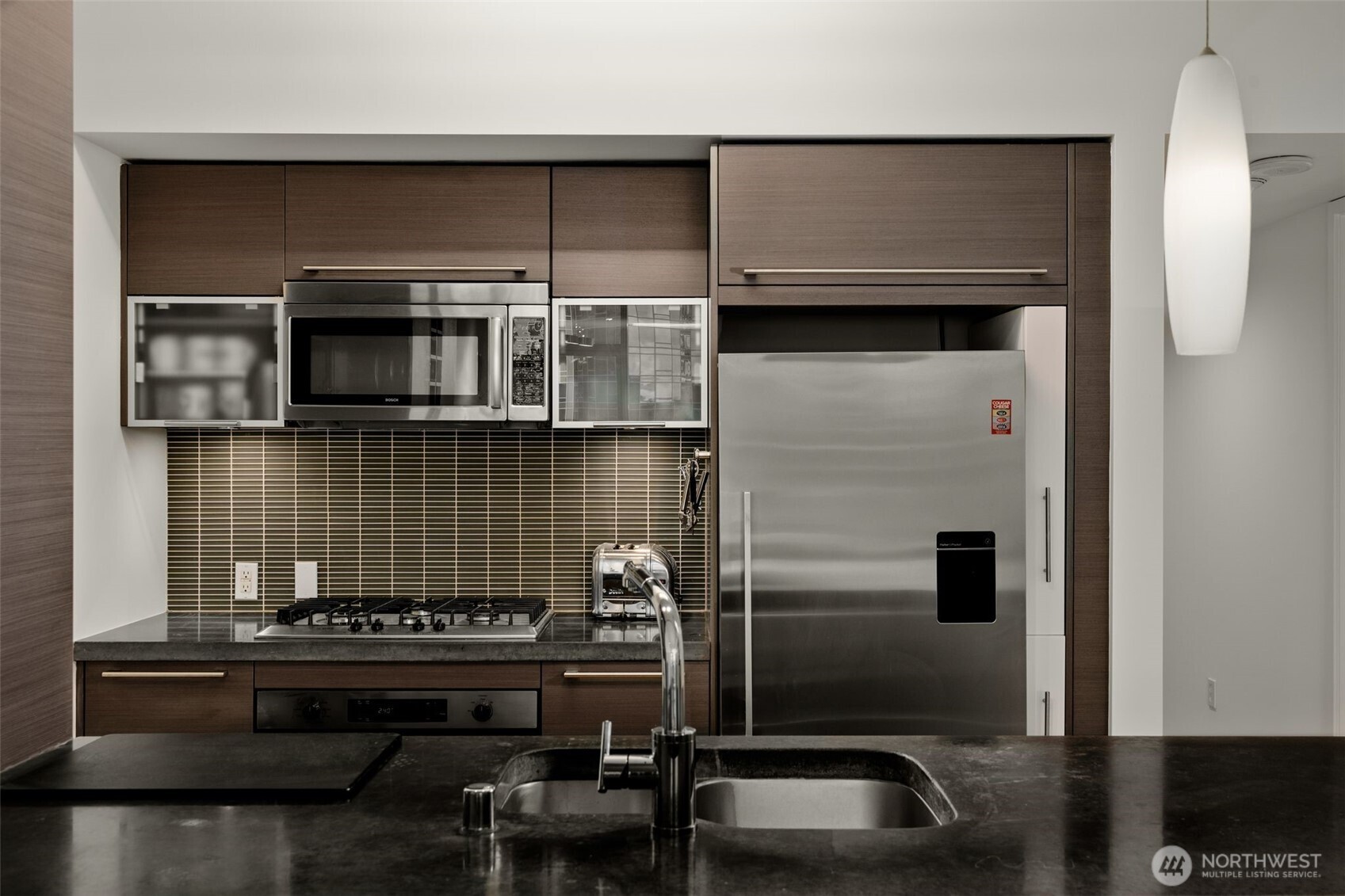 820 Blanchard Street, Unit 1301 Seattle, WA 98121 - Photo 14 of 29 a kitchen with a sink and a stove top oven