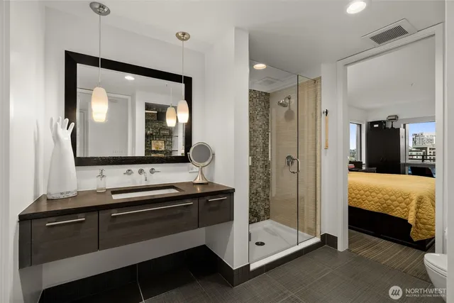 a en suite bathroom with a double vanity sink and a mirror