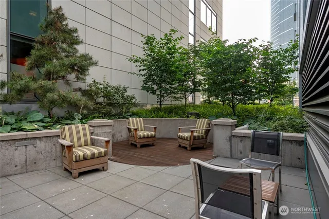 a backyard of a house with barbeque oven and outdoor seating