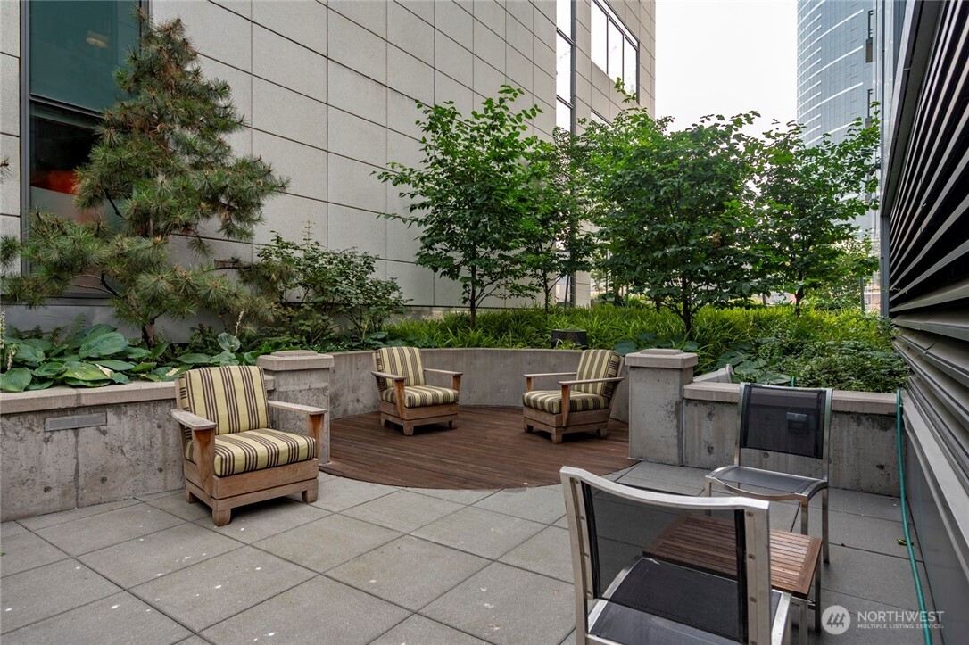 820 Blanchard Street, Unit 1301 Seattle, WA 98121 - Photo 25 of 29 a backyard of a house with barbeque oven and outdoor seating