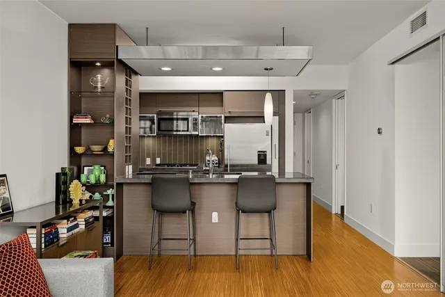 a kitchen with lots of counter top space and furniture