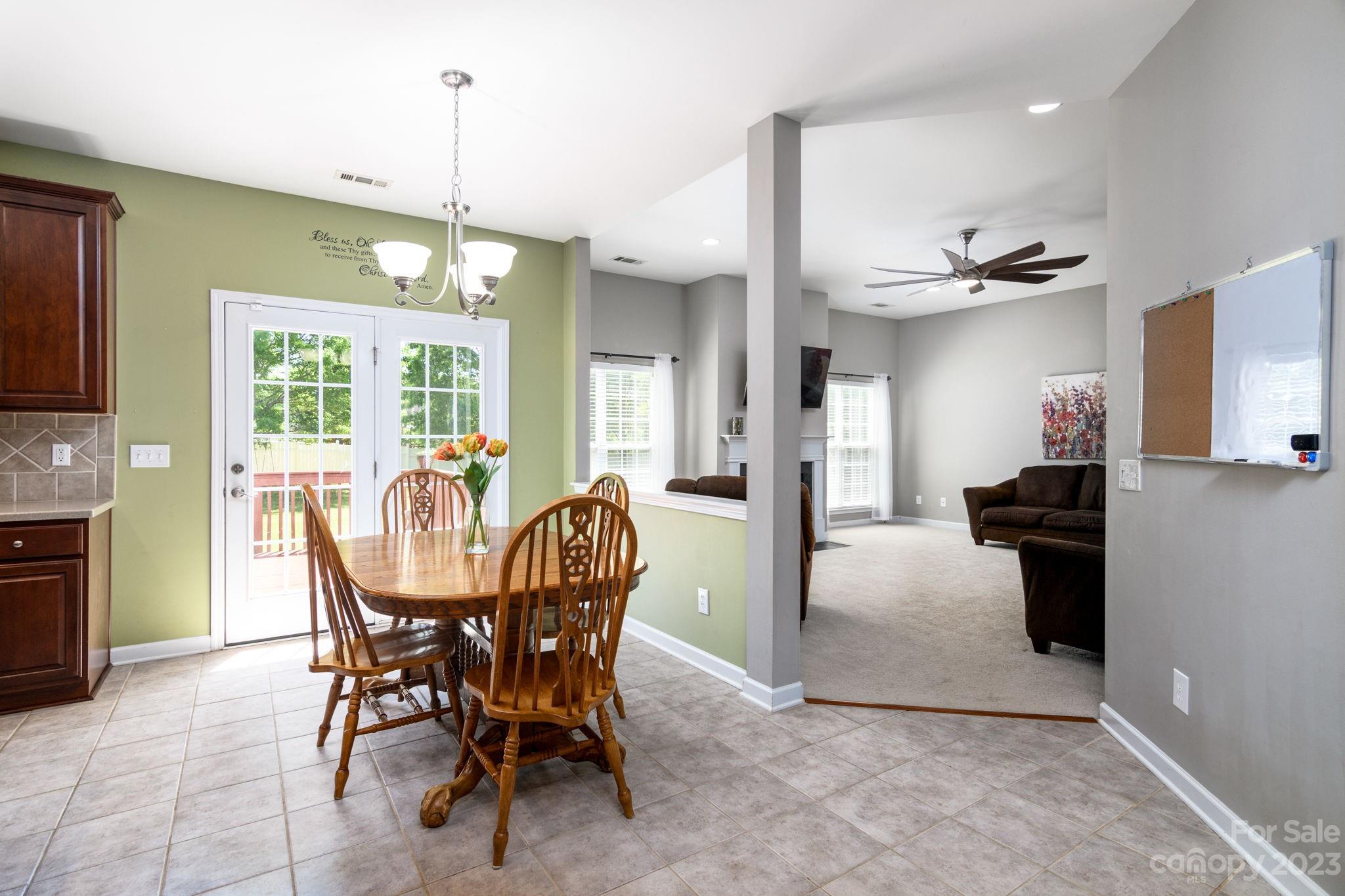 582 Evening Mist Drive Fort Mill, SC 29708 - Photo 11 of 31 a view of a dining room and livingroom with furniture wooden floor a chandelier