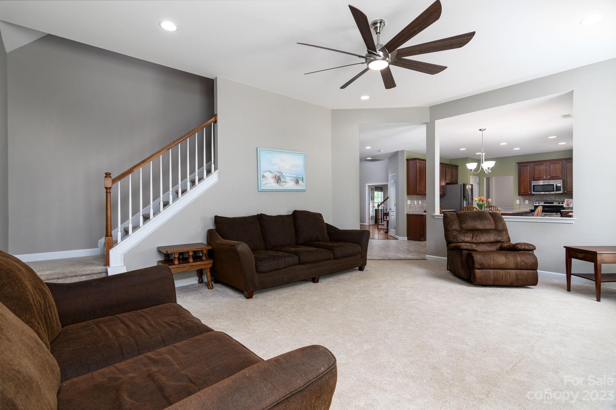 582 Evening Mist Drive Fort Mill, SC 29708 - Photo 14 of 31 a living room with furniture and a chandelier