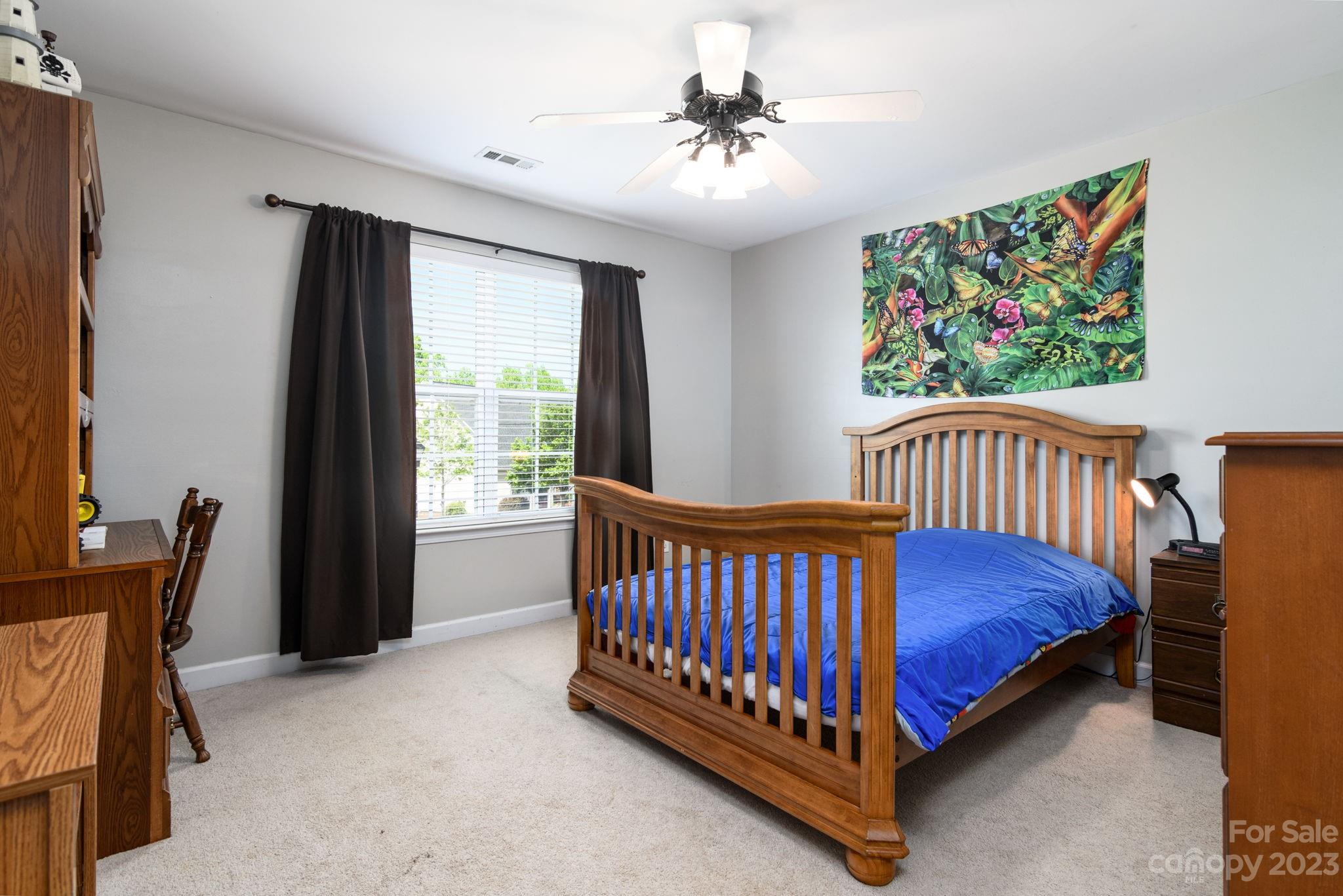 582 Evening Mist Drive Fort Mill, SC 29708 - Photo 25 of 31 a bed sitting in a bedroom next to a window