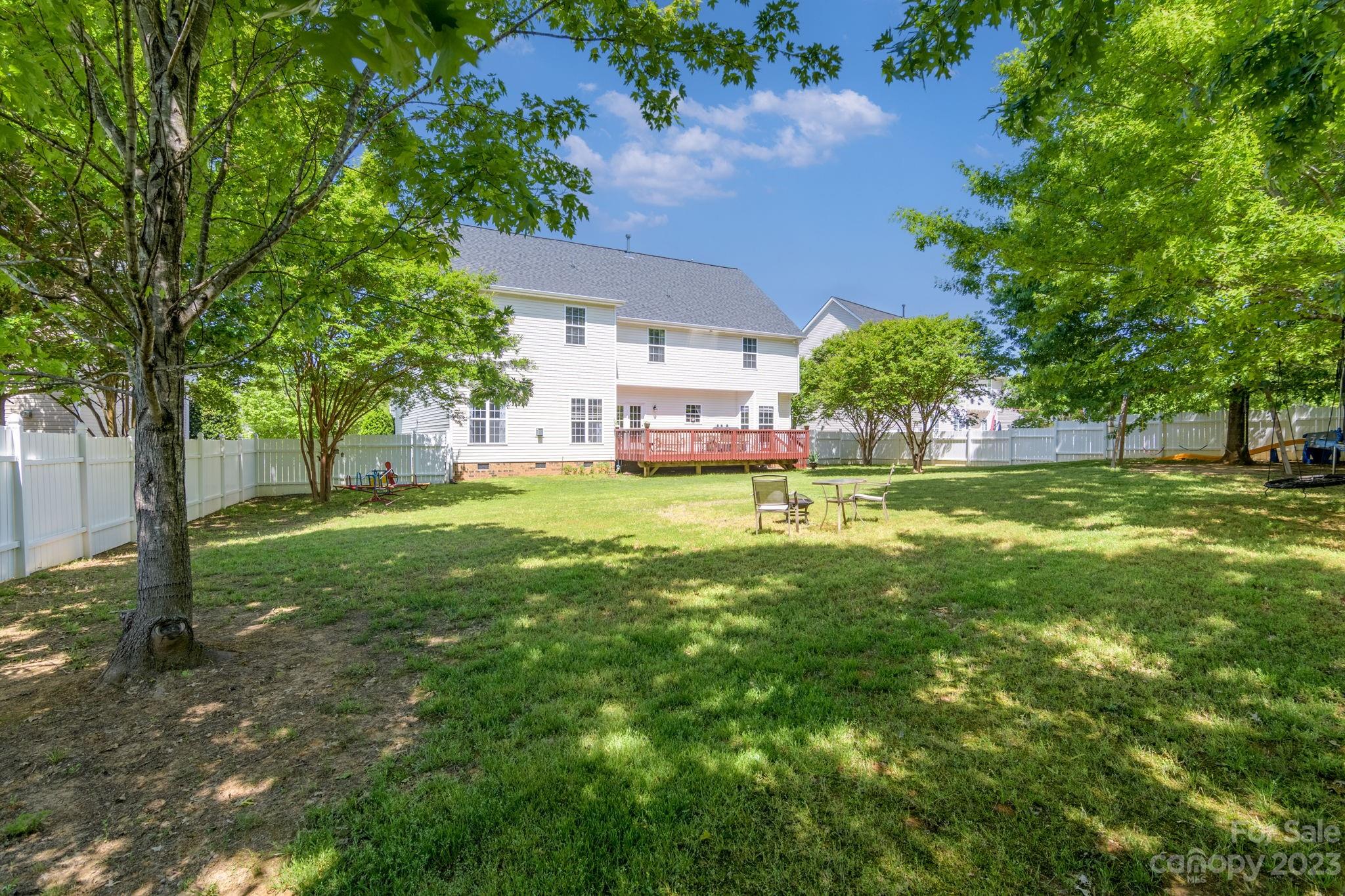 582 Evening Mist Drive Fort Mill, SC 29708 - Photo 29 of 31 a view of a house with a big yard potted plants and large tree