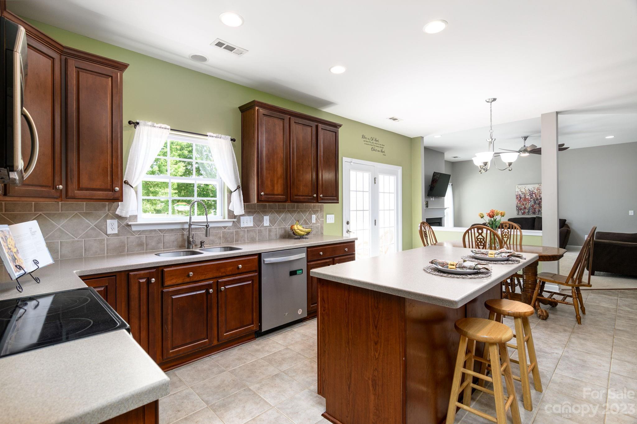 582 Evening Mist Drive Fort Mill, SC 29708 - Photo 8 of 31 a kitchen with a sink stove and cabinets