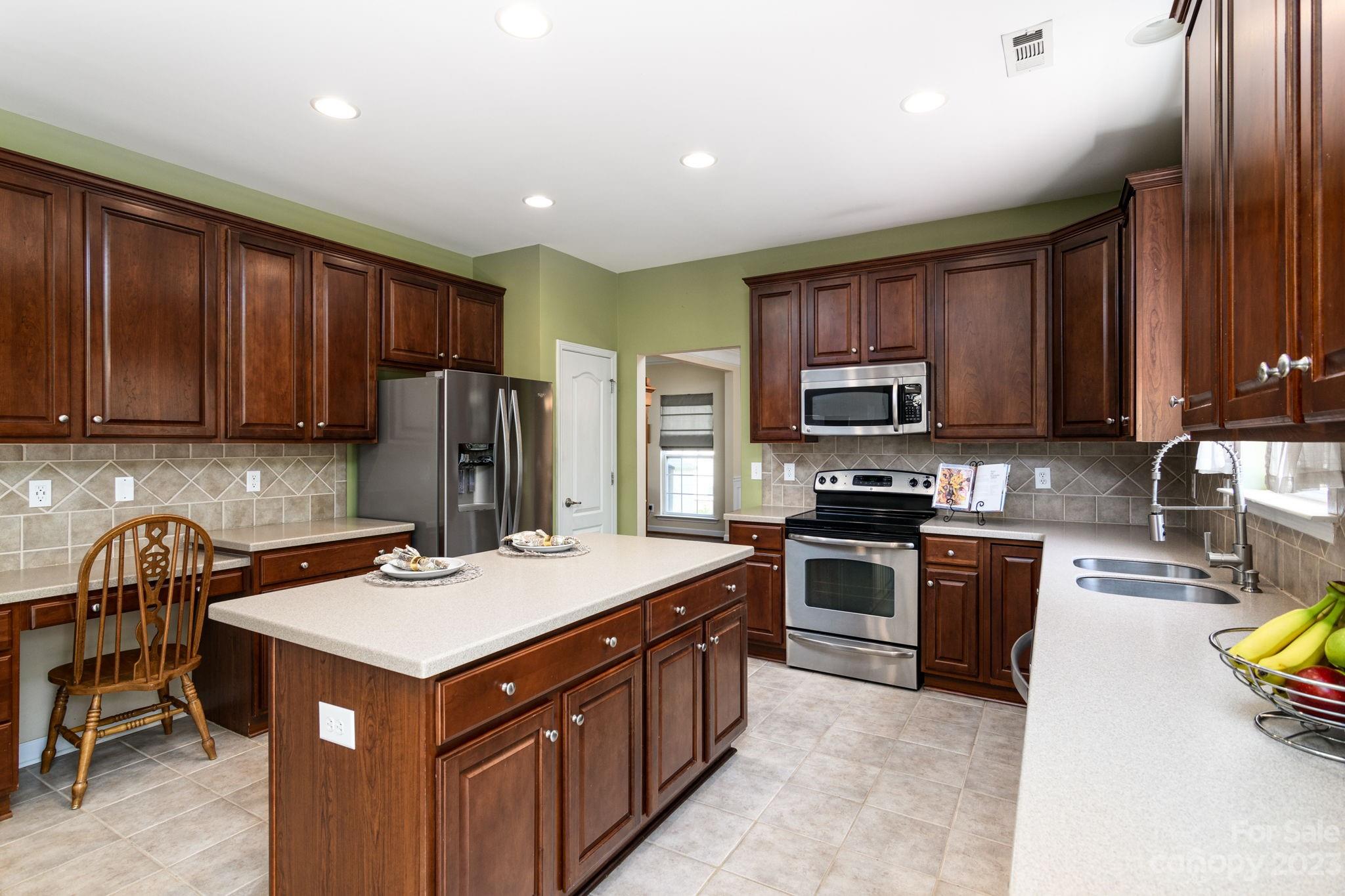 582 Evening Mist Drive Fort Mill, SC 29708 - Photo 9 of 31 a kitchen with kitchen island a sink stove and microwave