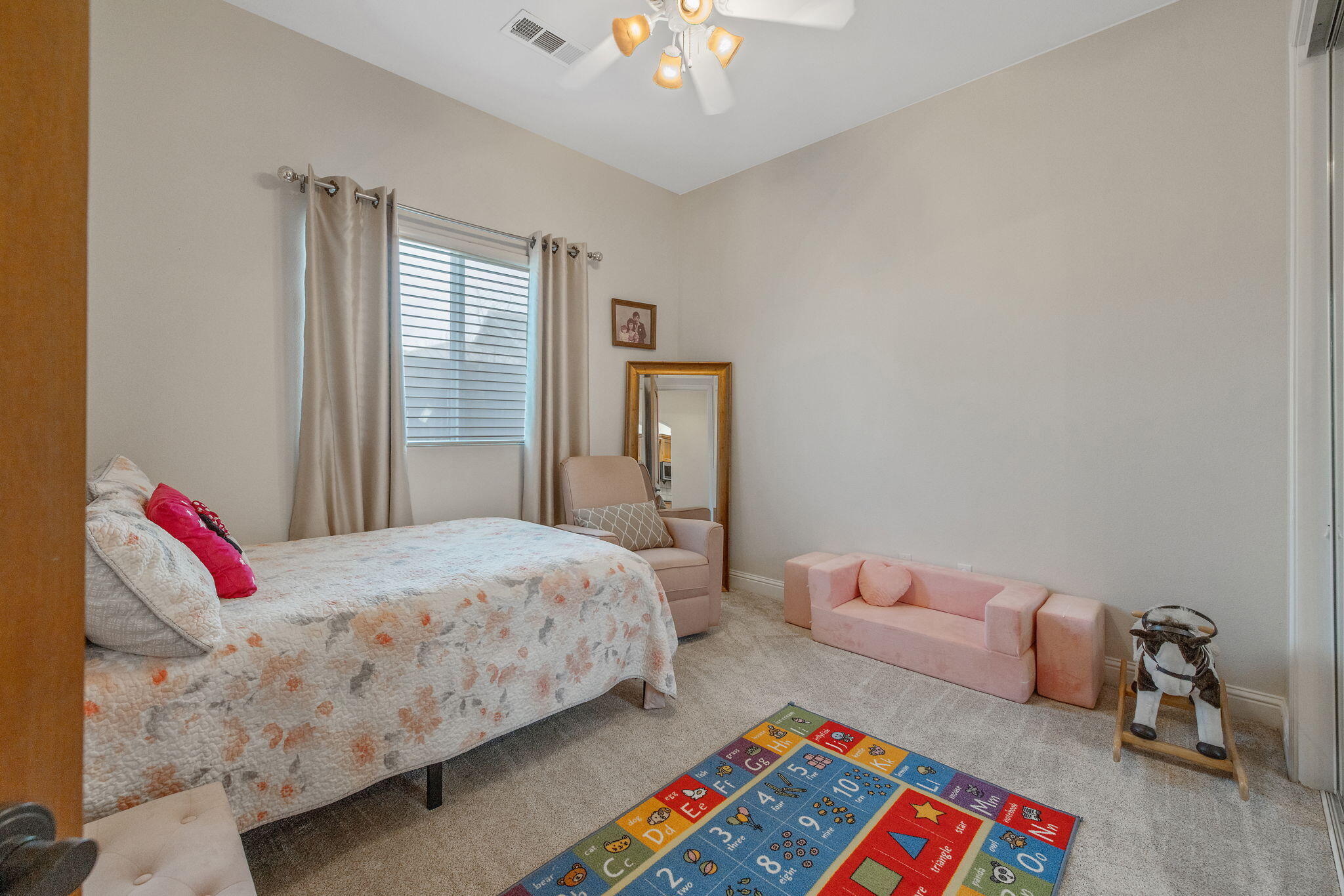 729 St Thomas Court Exeter, CA 93221 - Photo 38 of 66 a bedroom with a bed and a chandelier