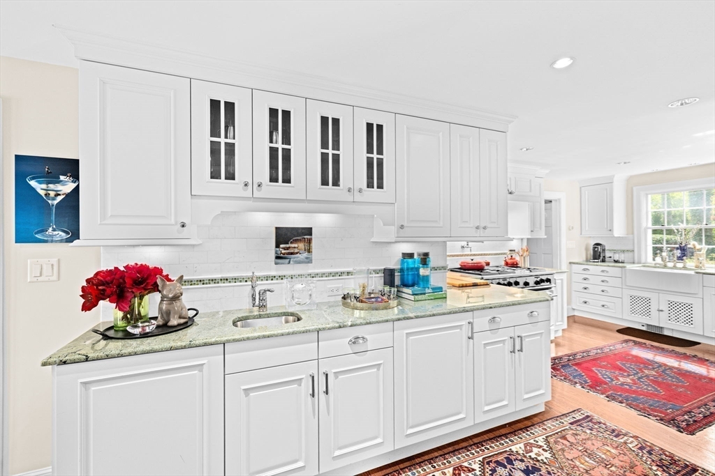 73 Pond Street Cohasset, MA 02025 - Photo 11 of 42 a kitchen with stainless steel appliances granite countertop a sink dishwasher stove and cabinets