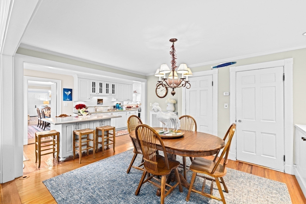 73 Pond Street Cohasset, MA 02025 - Photo 19 of 42 a dining room with furniture a chandelier and wooden floor