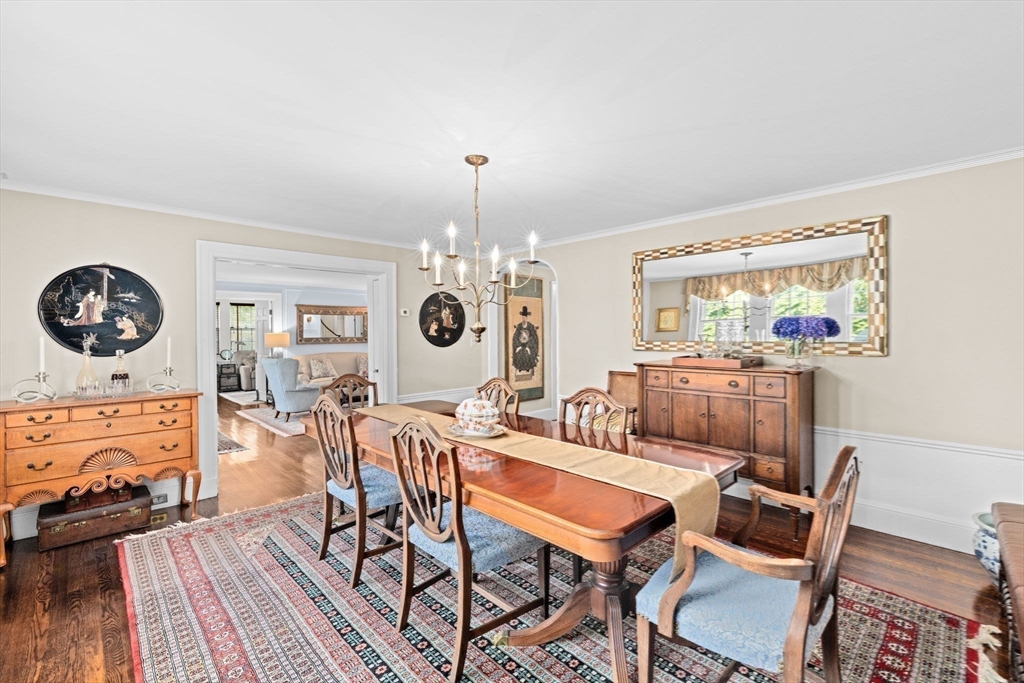 73 Pond Street Cohasset, MA 02025 - Photo 21 of 42 a view of a dining room with furniture a chandelier and wooden floor