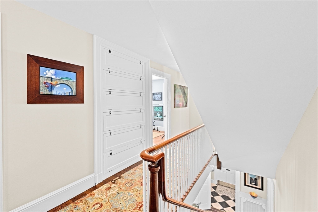 73 Pond Street Cohasset, MA 02025 - Photo 36 of 42 a view of a hallway with paintings on the wall