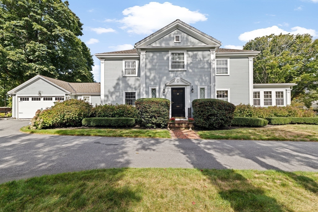 73 Pond Street Cohasset, MA 02025 - Photo 42 of 42 a front view of a house with a yard and potted plants