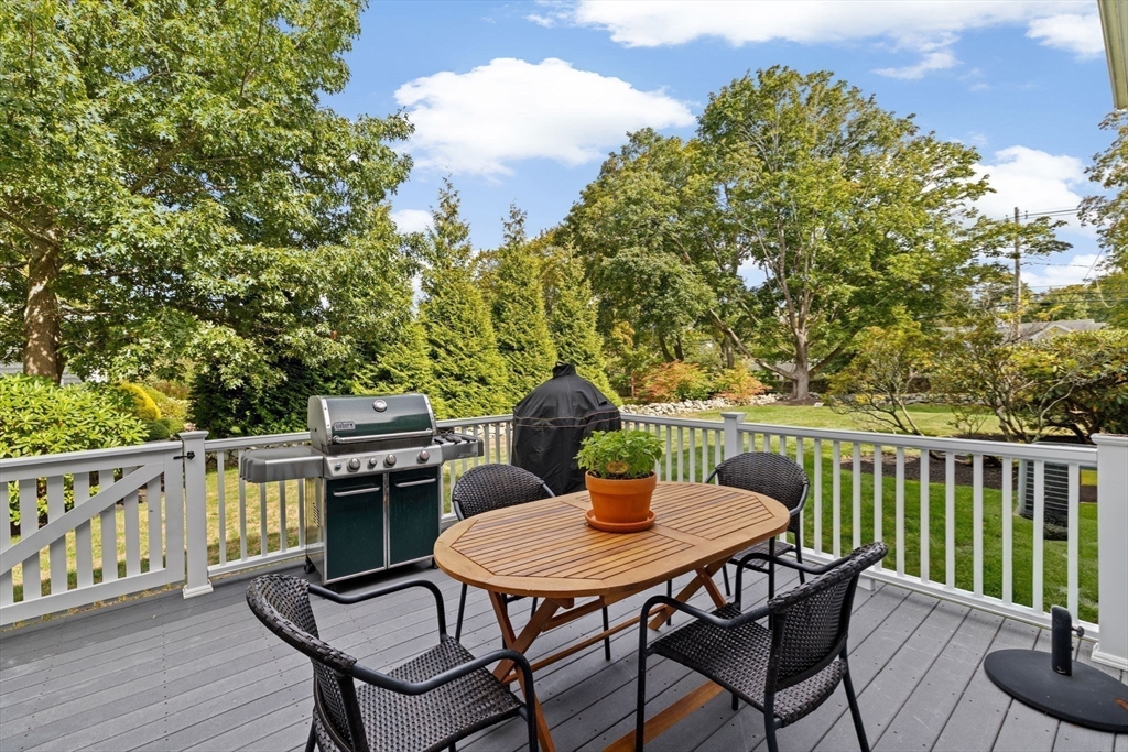 73 Pond Street Cohasset, MA 02025 - Photo 7 of 42 a view of a chairs and table on the deck