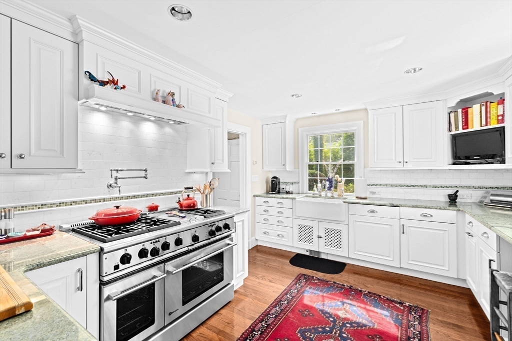 73 Pond Street Cohasset, MA 02025 - Photo 9 of 42 a kitchen with stainless steel appliances a stove and white cabinets