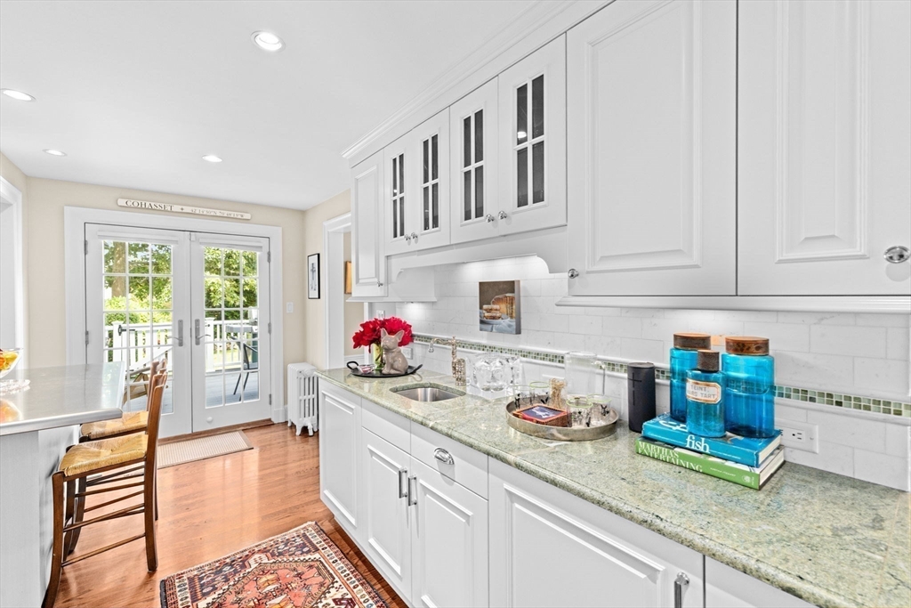73 Pond Street Cohasset, MA 02025 - Photo 10 of 42 a kitchen with granite countertop lots of clutter and stainless steel appliances