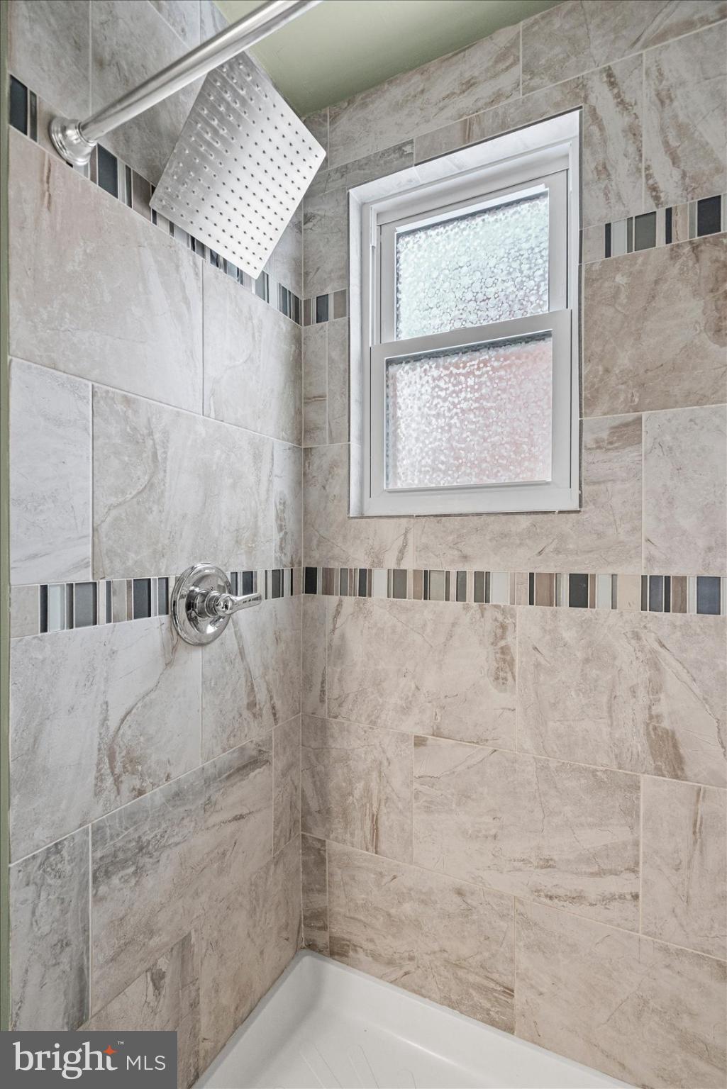 7708 Middlesex Place Parkville, MD 21234 - Photo 20 of 37 Stylish shower with modern tile accents.