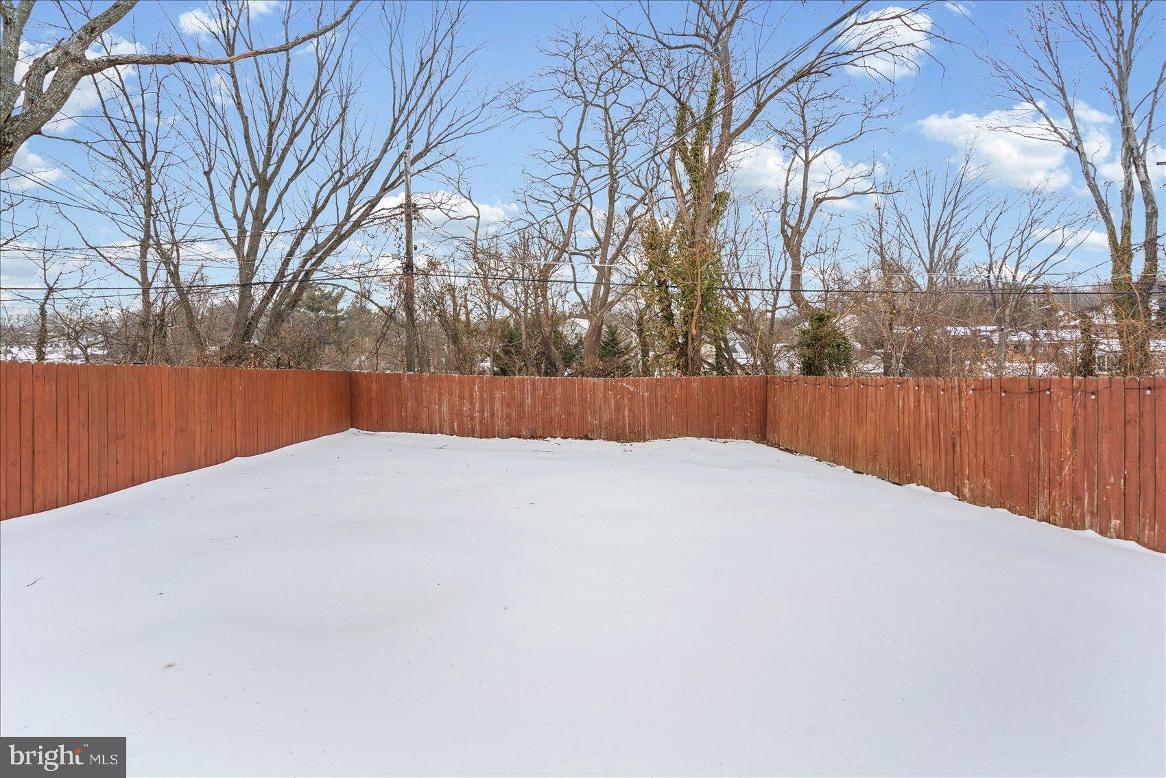 7708 Middlesex Place Parkville, MD 21234 - Photo 29 of 37 Serene winter landscape with fenced yard.