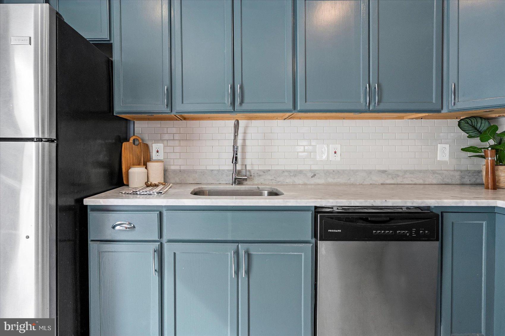 7708 Middlesex Place Parkville, MD 21234 - Photo 10 of 37 Chic blue cabinetry in a modern kitchen.
