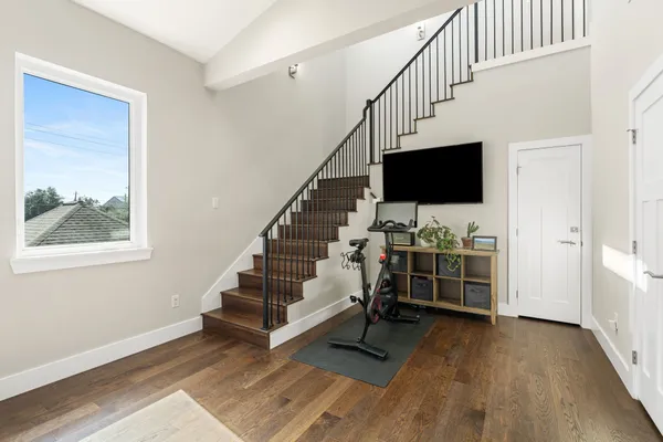 a room with stairs and a wooden floor