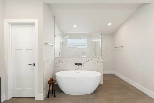 a bathroom with a bathtub and shower