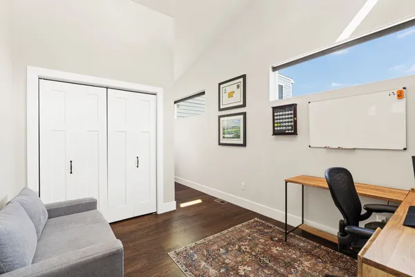 a view of a livingroom with workspace and a couch