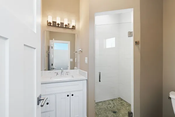 a bathroom with a sink a light fixture and a mirror
