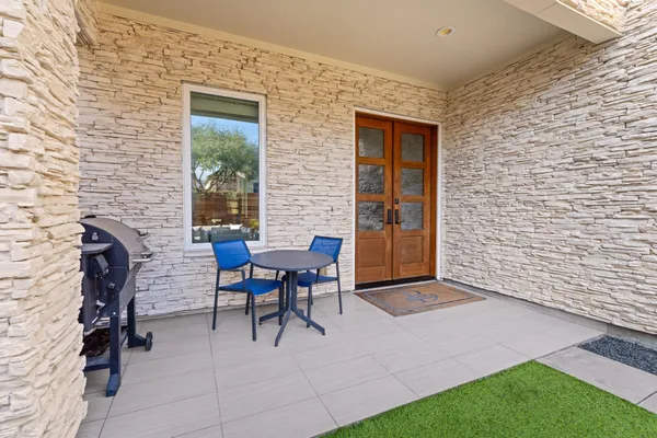 a view of a patio with a table and chairs