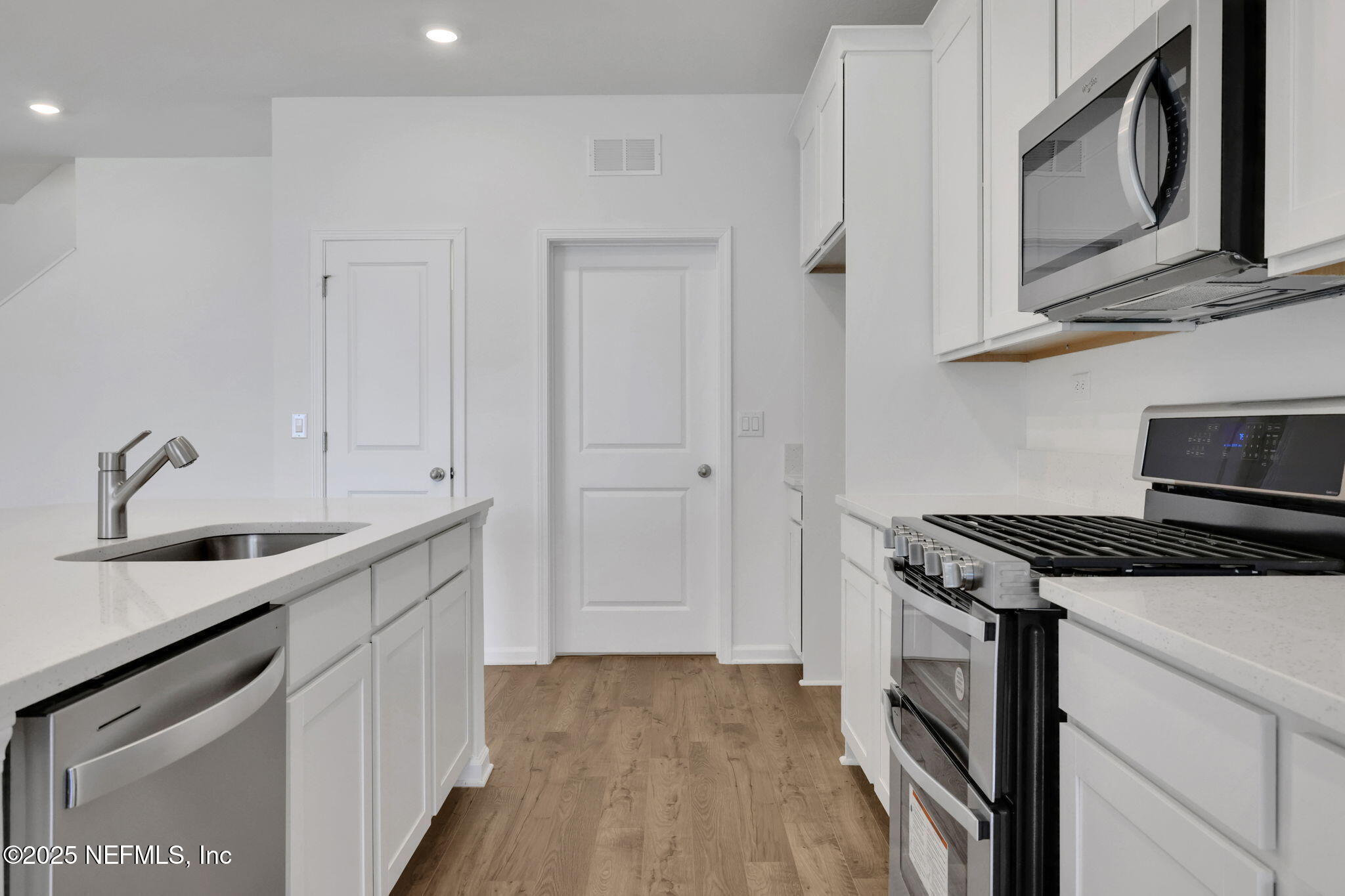 44 Martos Court St. Augustine, FL 32095 - Photo 11 of 40 a kitchen with stainless steel appliances granite countertop a stove and a microwave