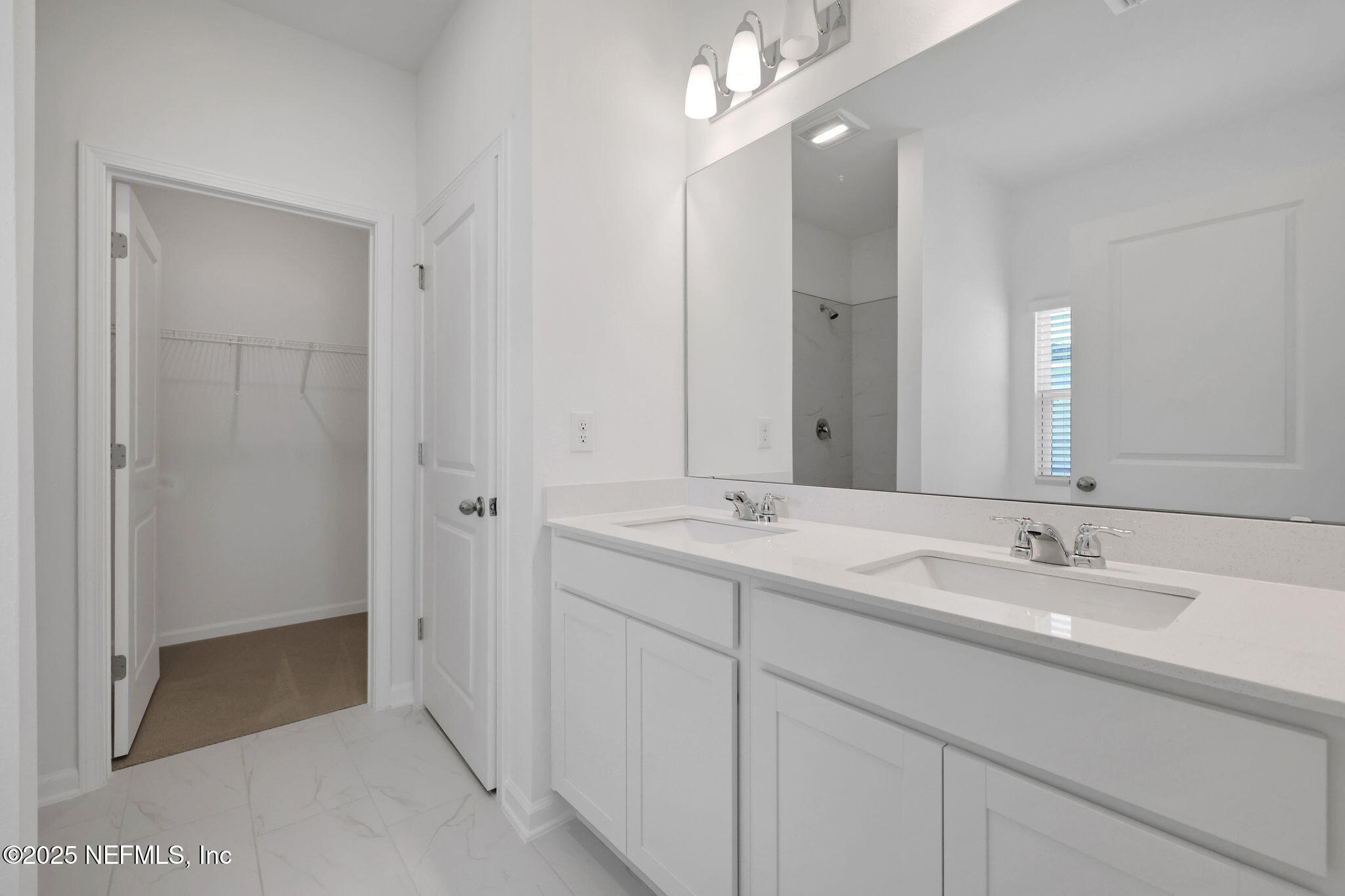 44 Martos Court St. Augustine, FL 32095 - Photo 21 of 40 a bathroom with double sink and a mirror